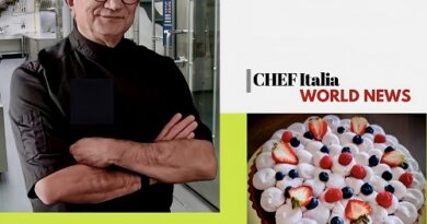 Portrait of Chef Ermenegildo Cimmino with arms crossed in a kitchen, yellow banner with his name, beside a berry-topped cake and Chef Italia World News branding.