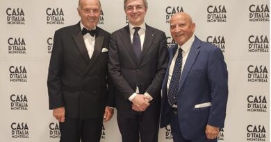Three men in dark suits posing for a photo at Casa d'Italia Montreal, backdrop shows the event logo.