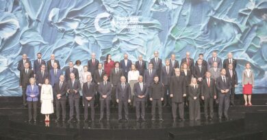 Group photo of European officials on a multi-tiered stage with a blue textured backdrop reading European Political Community 2026.