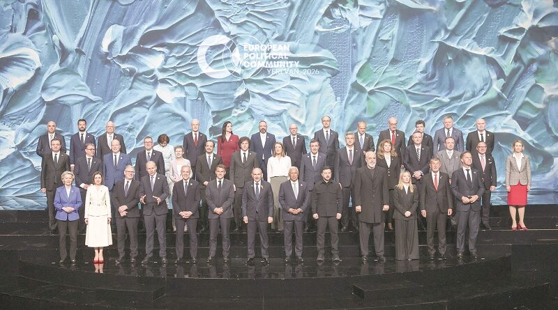 Group photo of European officials on a multi-tiered stage with a blue textured backdrop reading European Political Community 2026.