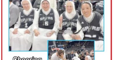 Nuns in San Antonio Spurs jerseys sit together courtside at a basketball game, smiling; an inset shows them blessing players on the court.