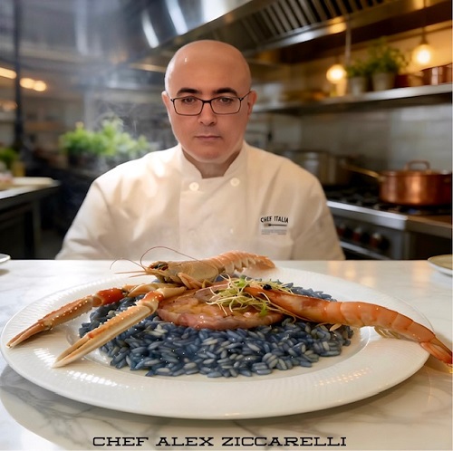 Chef Alex Ziccarelli in a professional kitchen presents squid ink pasta topped with large prawns.