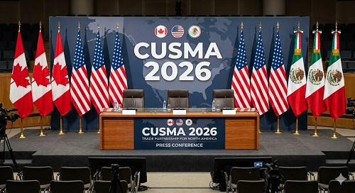 Conference stage with three chairs and microphones, flanked by flags of Canada, the United States, and Mexico; CUSMA 2026 backdrop.