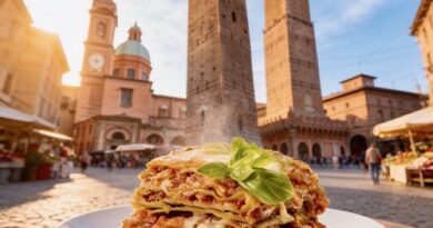 Lasagna on a plate garnished with basil, in a sunlit Bologna square with the Two Towers in the background.